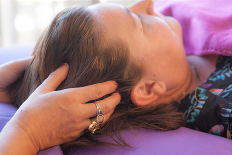 Woman receiving an Access Consciousness The Bars treatment.