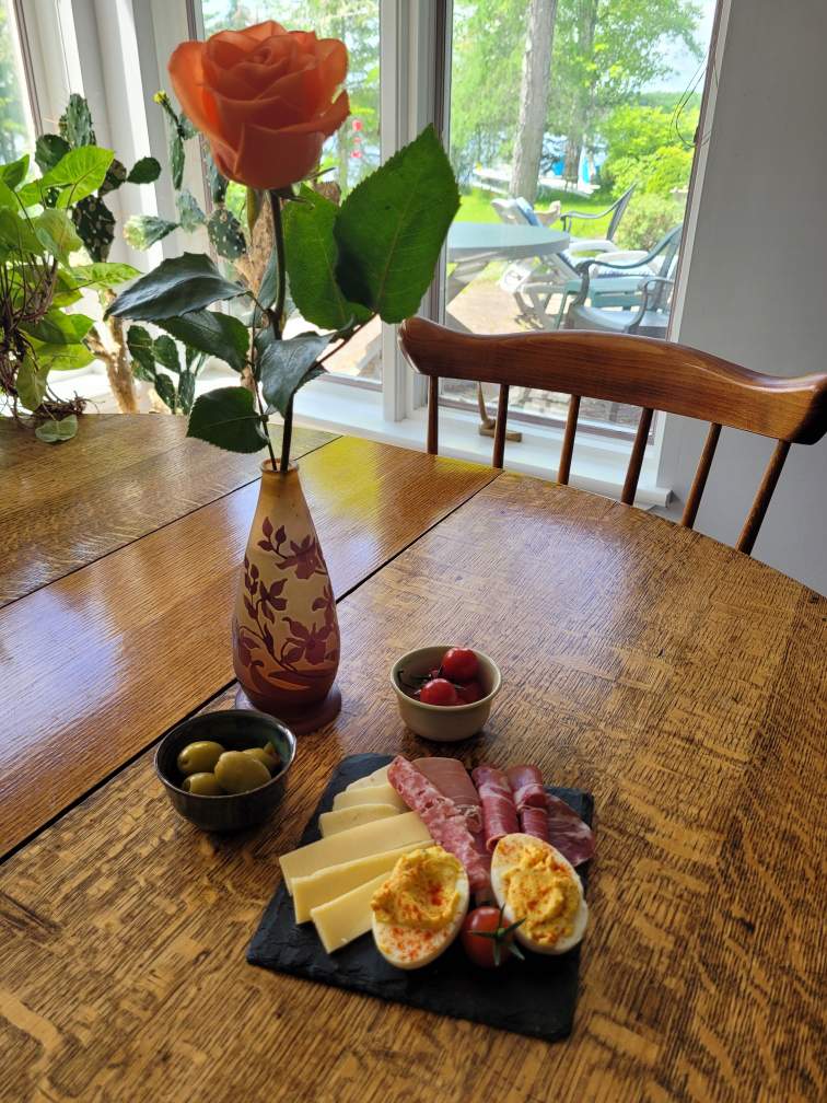 Charcuterie board on classic wood table in sunny kitchen