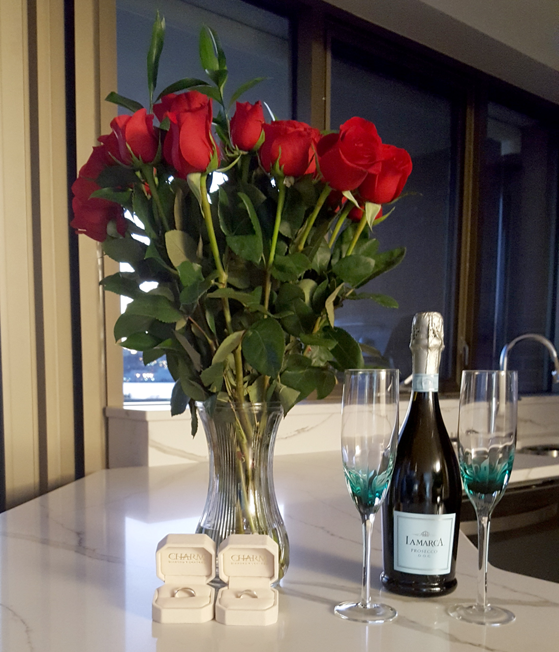 Bouquet of Red roses, champagne and wedding rings